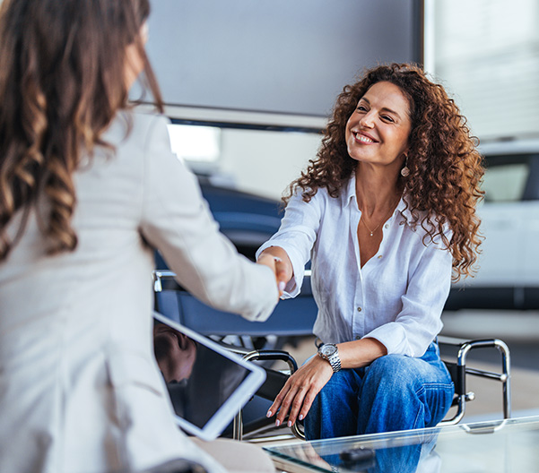 Saleswoman shaking hands with customer