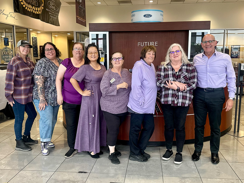 People posing while wearing purple