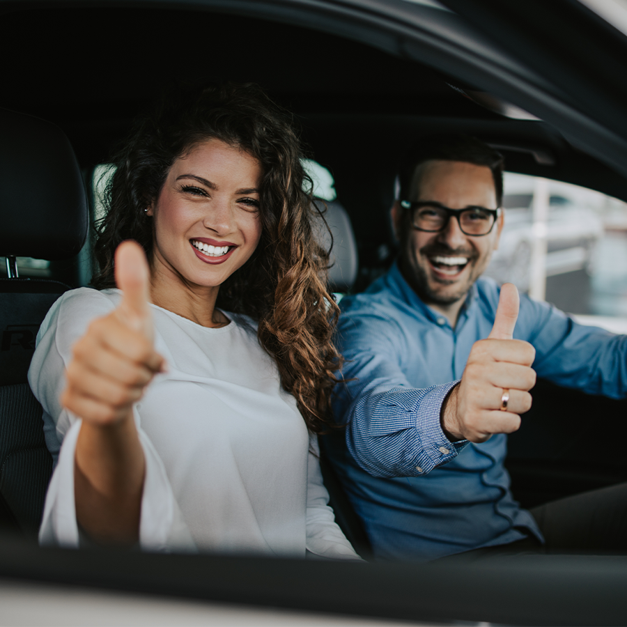 Happy couple buying new car