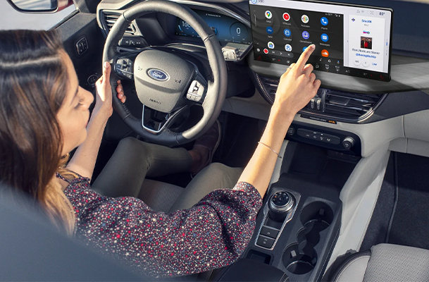 Woman using the interior infotainment screen in her ford