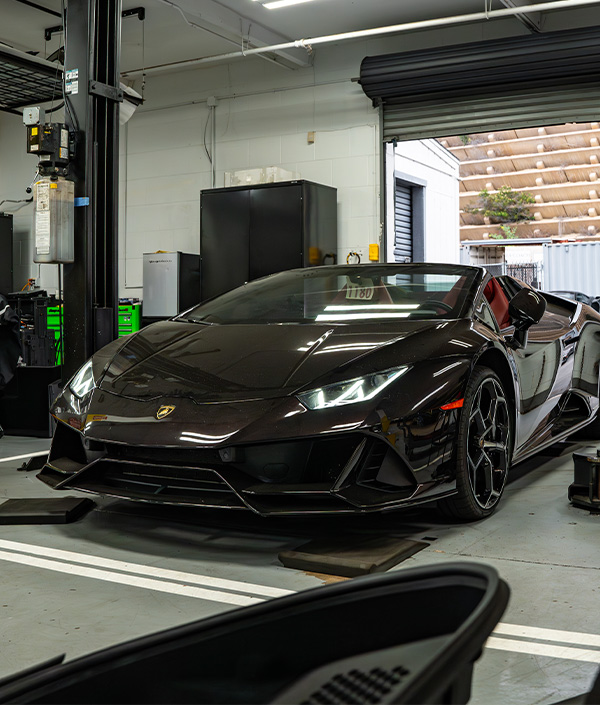 3/4 front shot of Lamborghini pulling into service bay