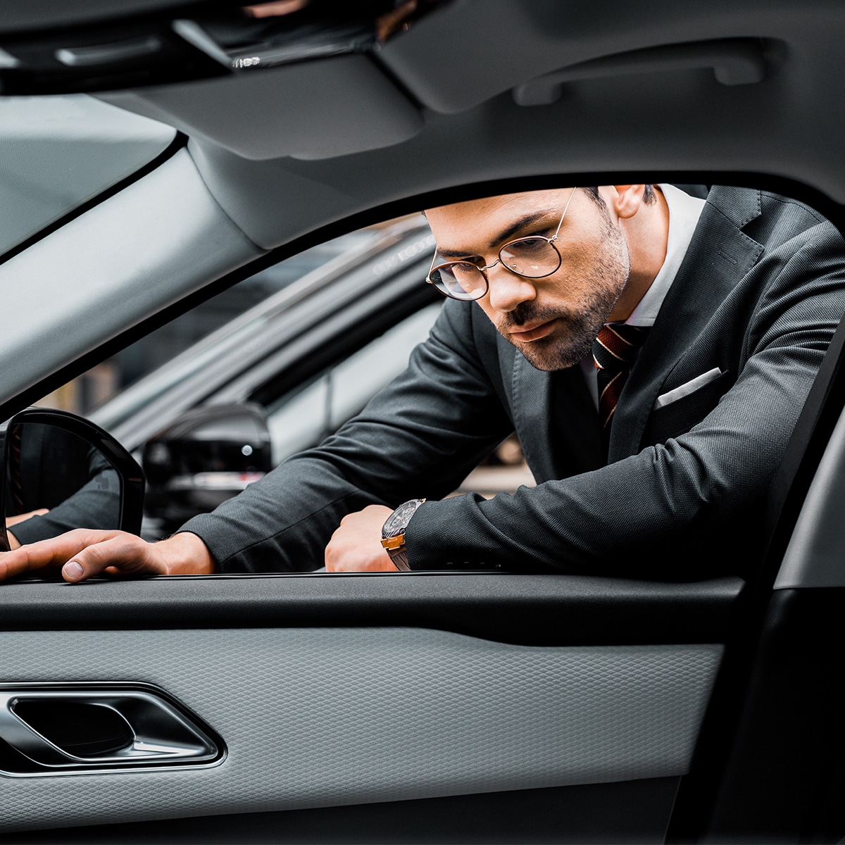 Salesperson looking into a vehicle