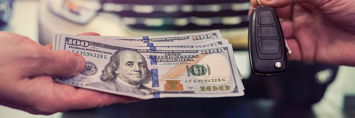 purchase deal of buy or rent used car. Hand with dollar money and car keys