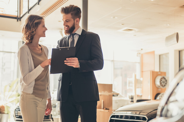 Salesperson with customer in dealership