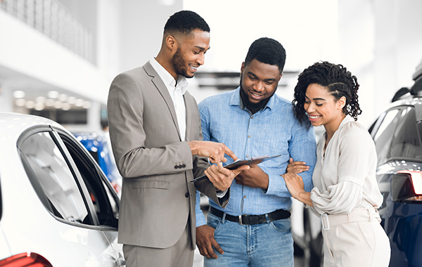 Dealership employee showing customer options on device