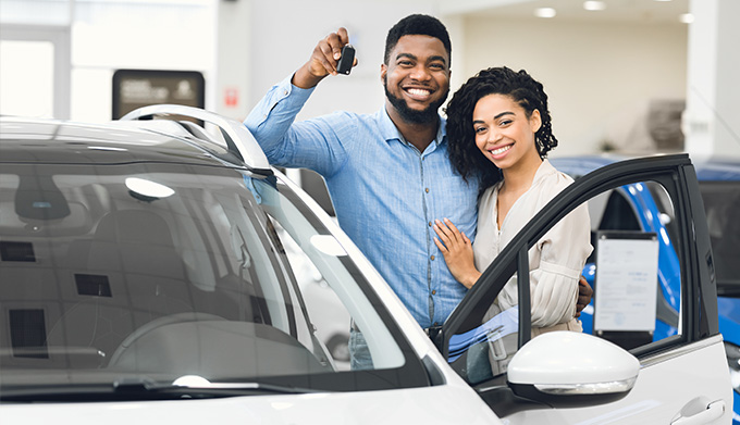 Happy couple at a dealership