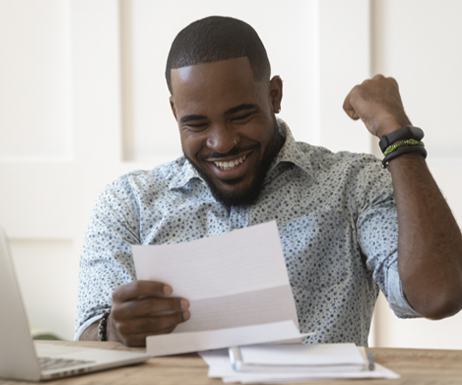 Person looking at documents and smiling with hand help up