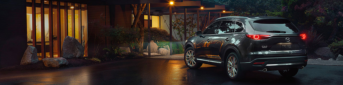 MAZDA CX-9 parked outside a home at night