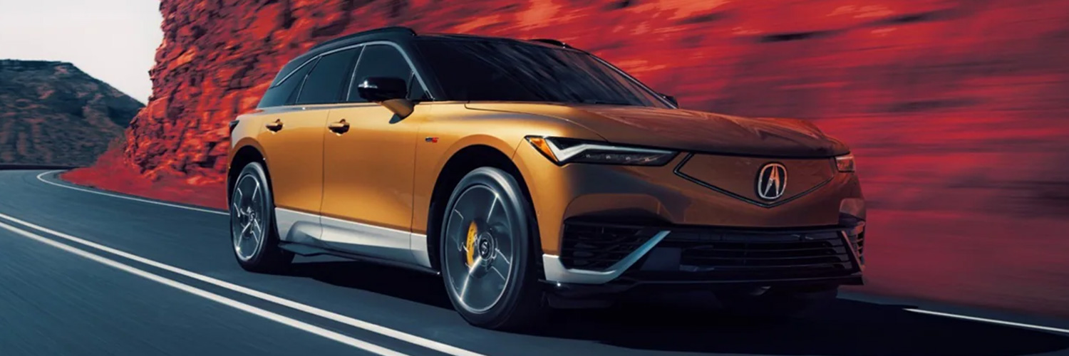 Front 3/4 shot of 2024 Acura ZDX driving down canyon road