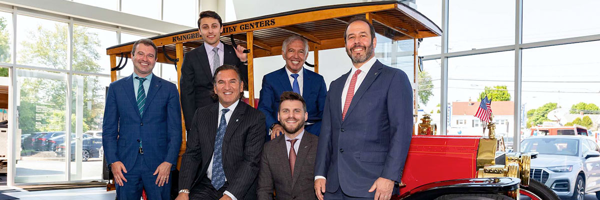 Hoffman family in frony of a dealership showroom background