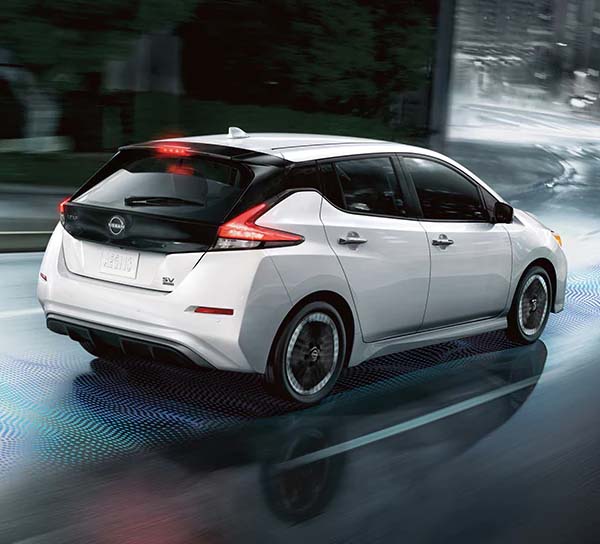 New Nissan LEAF shown in action driving down a wet road at night