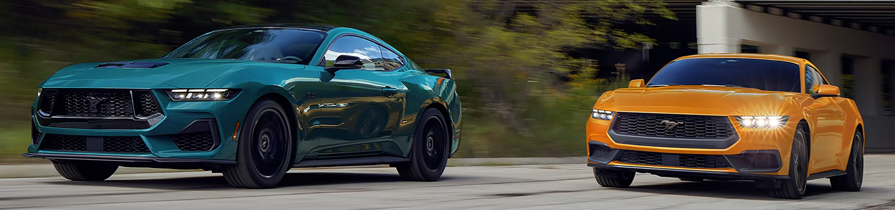 A 2026 Ford Mustang® GT Fastback and a 2026 Ford Mustang® EcoBoost® Fastback being driven on a highway