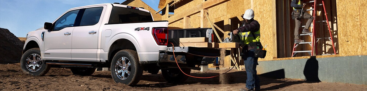 Construction workers working around a 2021 Ford F 1 50