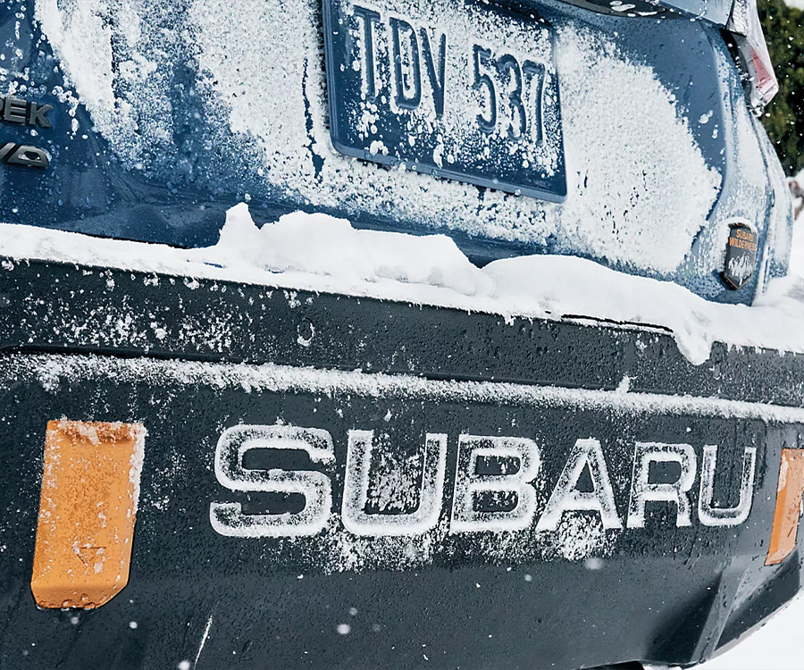 A close up of a snow covered bumper of a Subaru Crosstrek compact SUV 