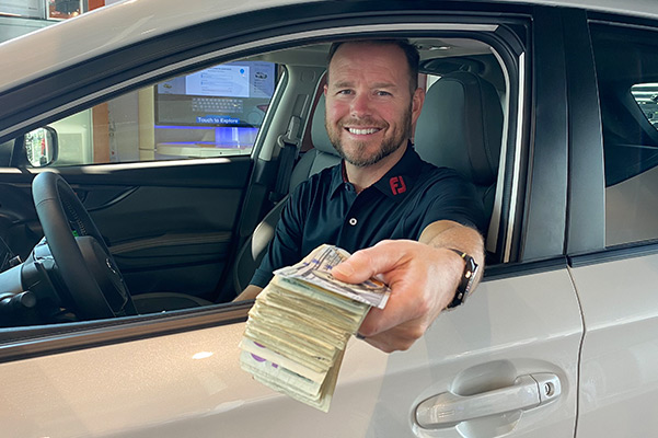 Salesman handing stack of money