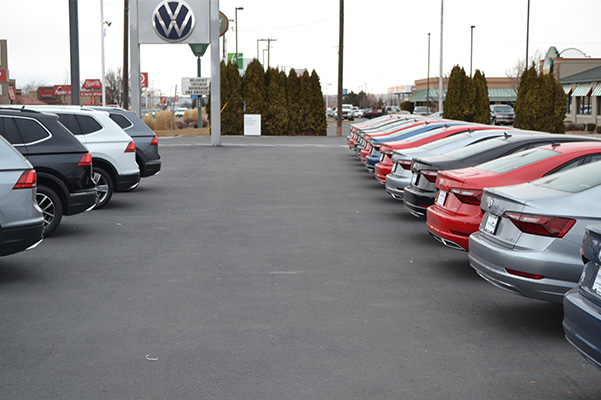 Shot of Volkswagens all parked nicely in the dealership lot.