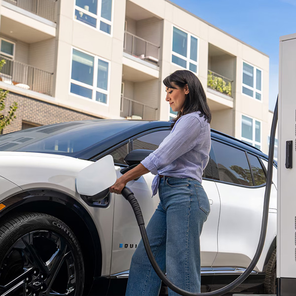 Woman plugging up her Chevrolet EV