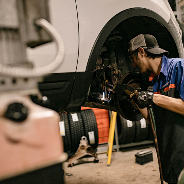 Ford Service worker working on a vehicle.