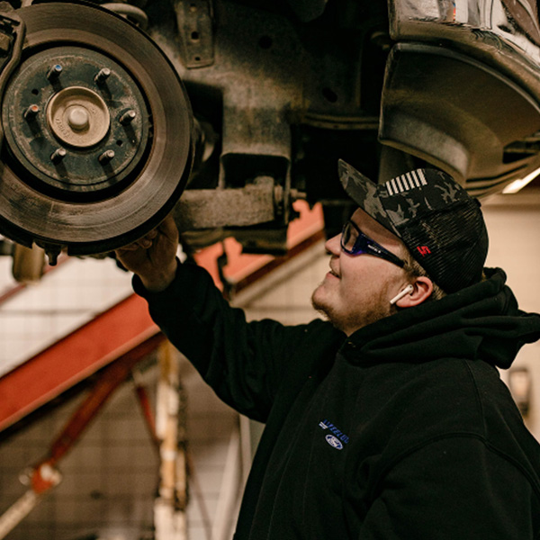 Ford Service worker working on a vehicle.