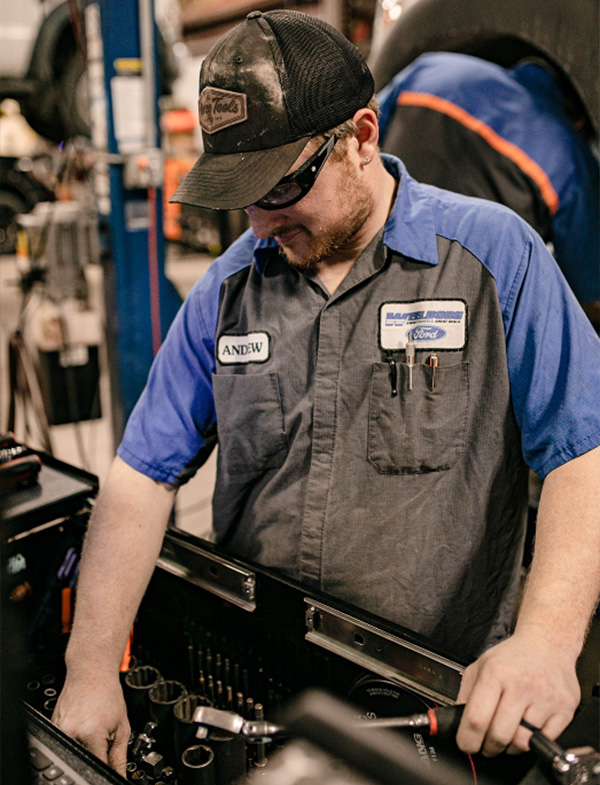 Ford Service worker working on a vehicle.
