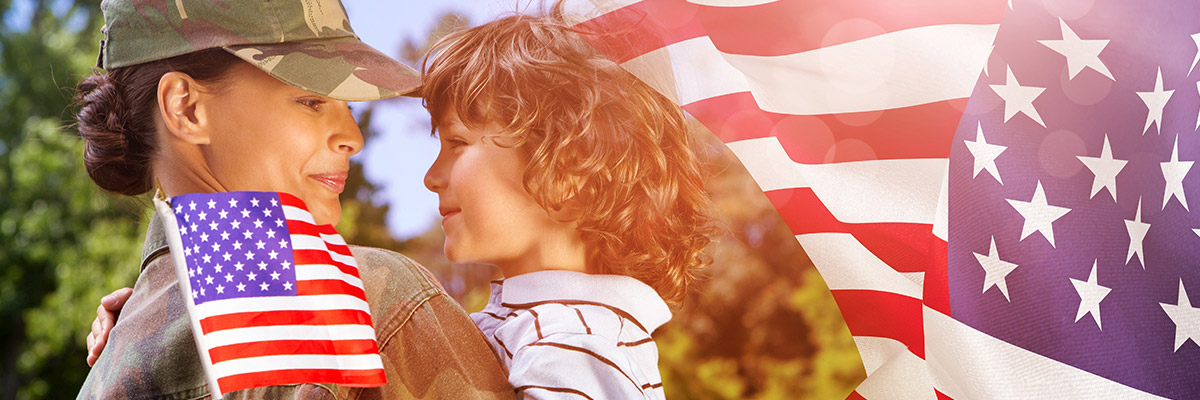 Soldier holding son with American Flags