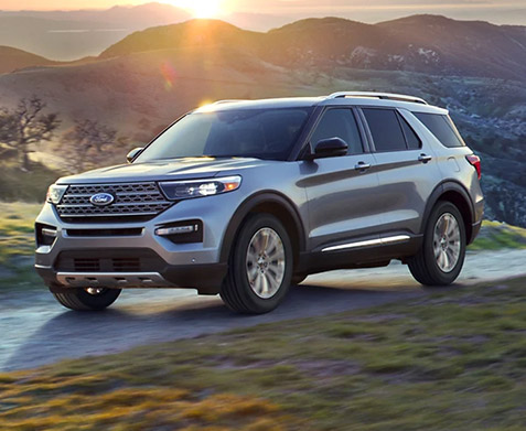 Ford Explorer driving at sunset