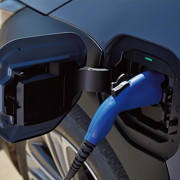 Close up of a Subaru plugged in charging
