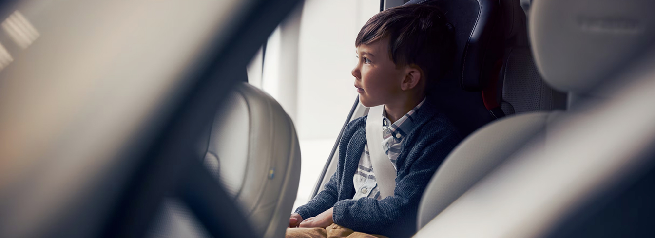 A child sat on child seat looking outside.